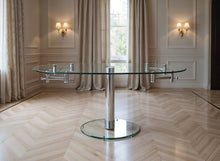 Load image into Gallery viewer, 40" Clear and Silver Glass and Metal Self-Storing Leaf Motion Extendable Dining Table
